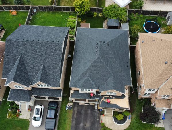 asphalt shingle roof installation on residential house by roofing contractors