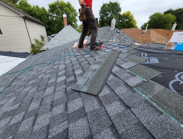 new asphalt shingle roof on modern home under blue sky