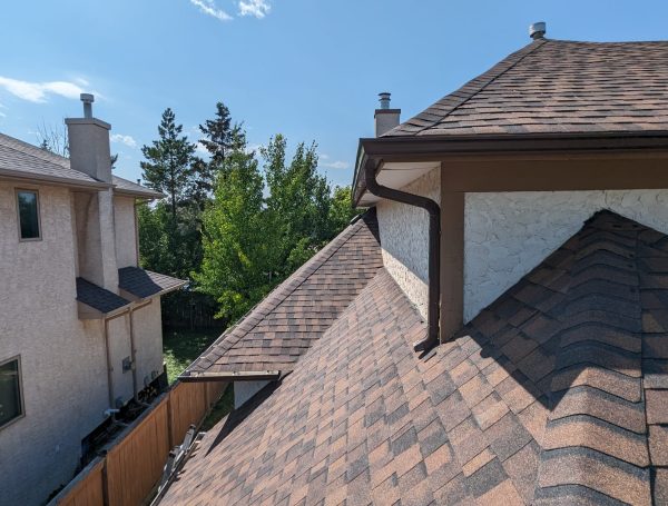 high-quality asphalt shingle roofing installed on suburban home