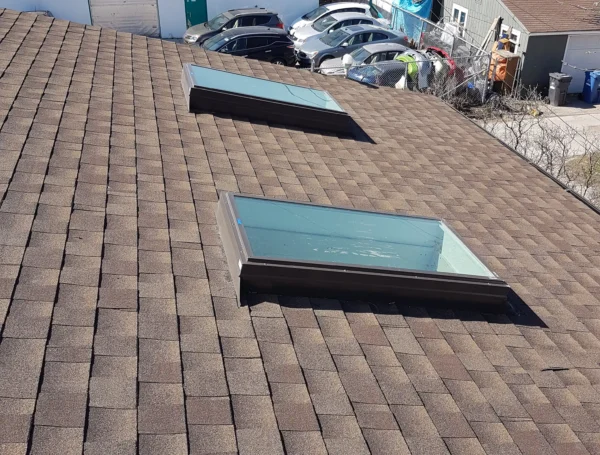 Roofing technician performing roof maintenance on house rooftop