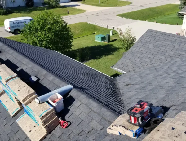 Roof repair work in progress on residential shingle roof