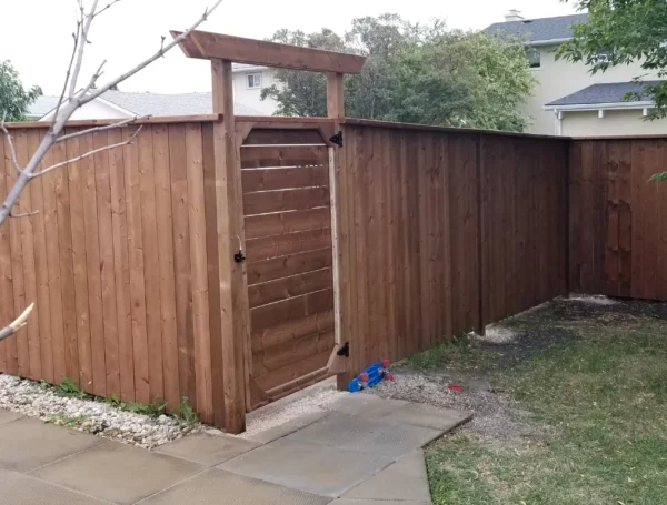 residential fence construction with wood and metal railing