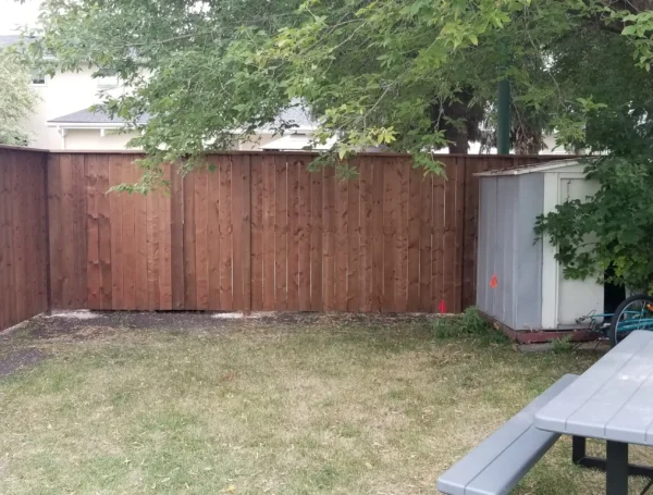 residential fence construction with wood and metal railing