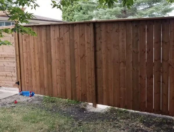 residential fence construction with wood and metal railing