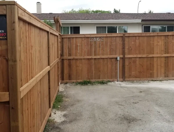 residential fence construction with wood and metal railing