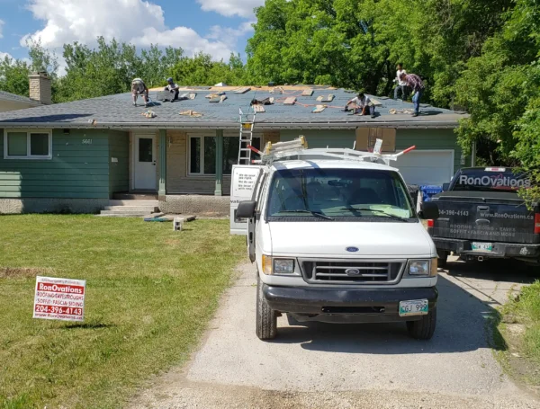 Roofing contractor inspecting and repairing roof damage