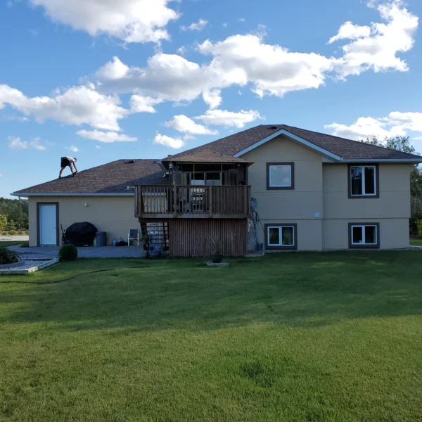 Roofer working on shingle roof maintenance and repair