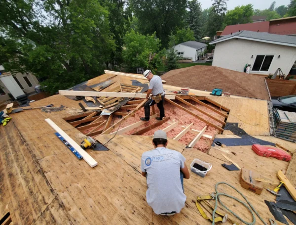 Roof maintenance work in progress on residential asphalt shingle roof