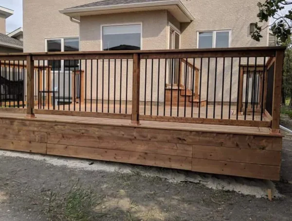 wooden backyard deck with modern railing installation