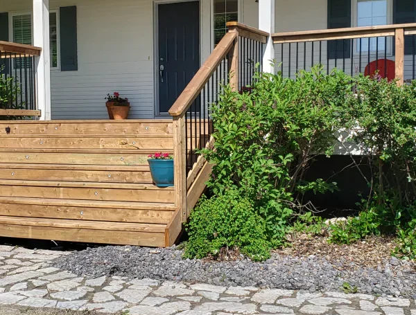 residential deck construction with wood and metal railing