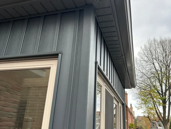 Professional installation of eavestrough and soffit on house roofline