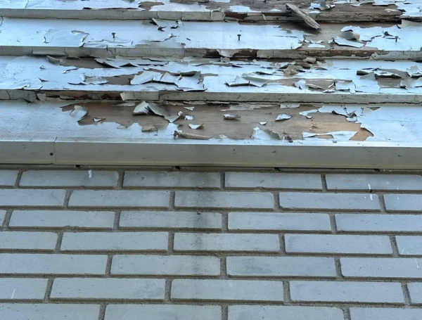 Roofing contractor inspecting and repairing roof damage