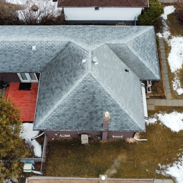 Roof maintenance work in progress on residential asphalt shingle roof
