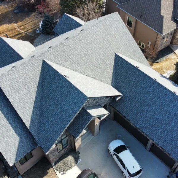 Professional roofer inspecting and maintaining residential roof
