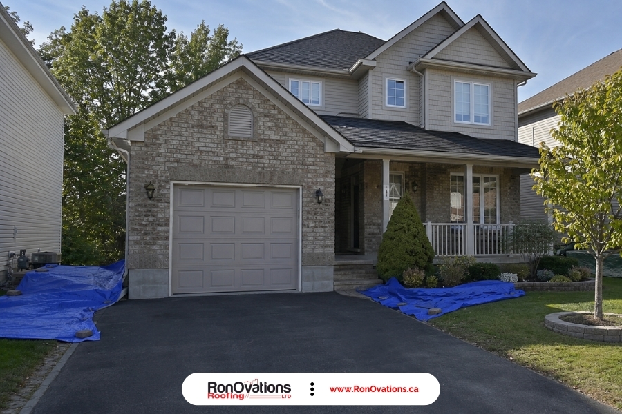 Roof replacement safety tips showing a cleared driveway and protected work area before roofing starts