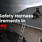 Roofer using a properly anchored safety harness on a Canadian residential roof